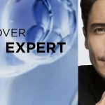 Advertisement for L’Oréal Men Expert skincare; man holding a blue bottle against a split blue/neutral background.